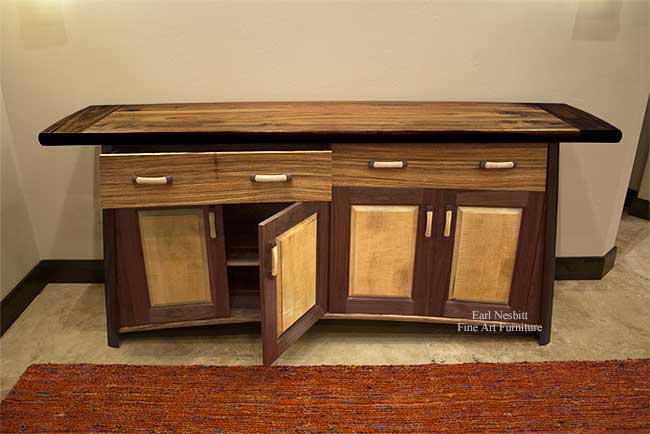custom made contemporary cabinet with one door and one drawer open showing walnut top
